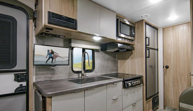 The kitchen of the 2100BH has great appliances and storage for great meals while camping.